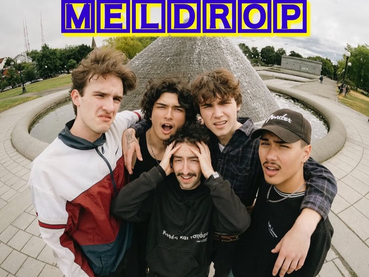 Meldrop band promo photo — five members posing together at an outdoor fountain
