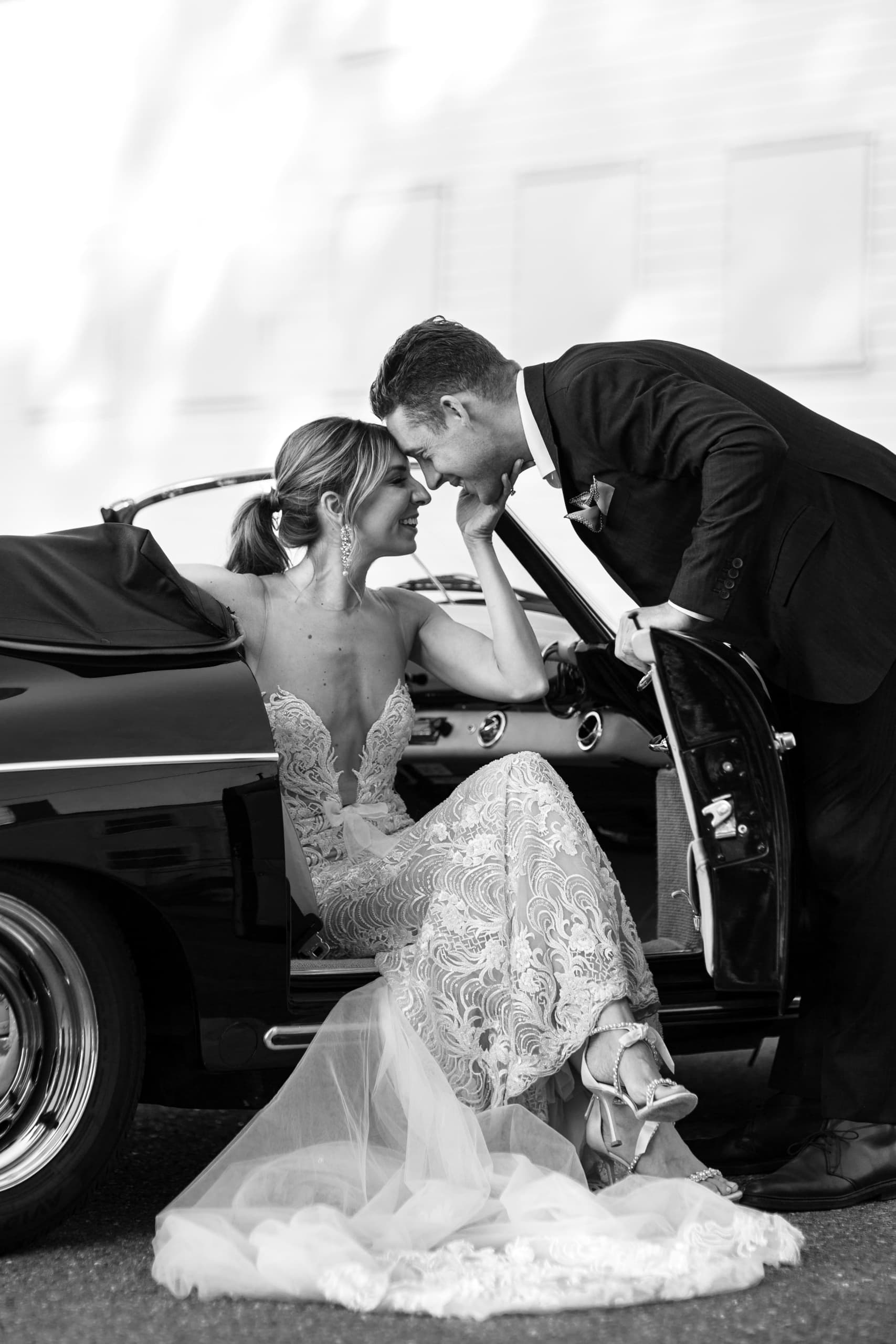 A bride and groom on their wedding day touching heads