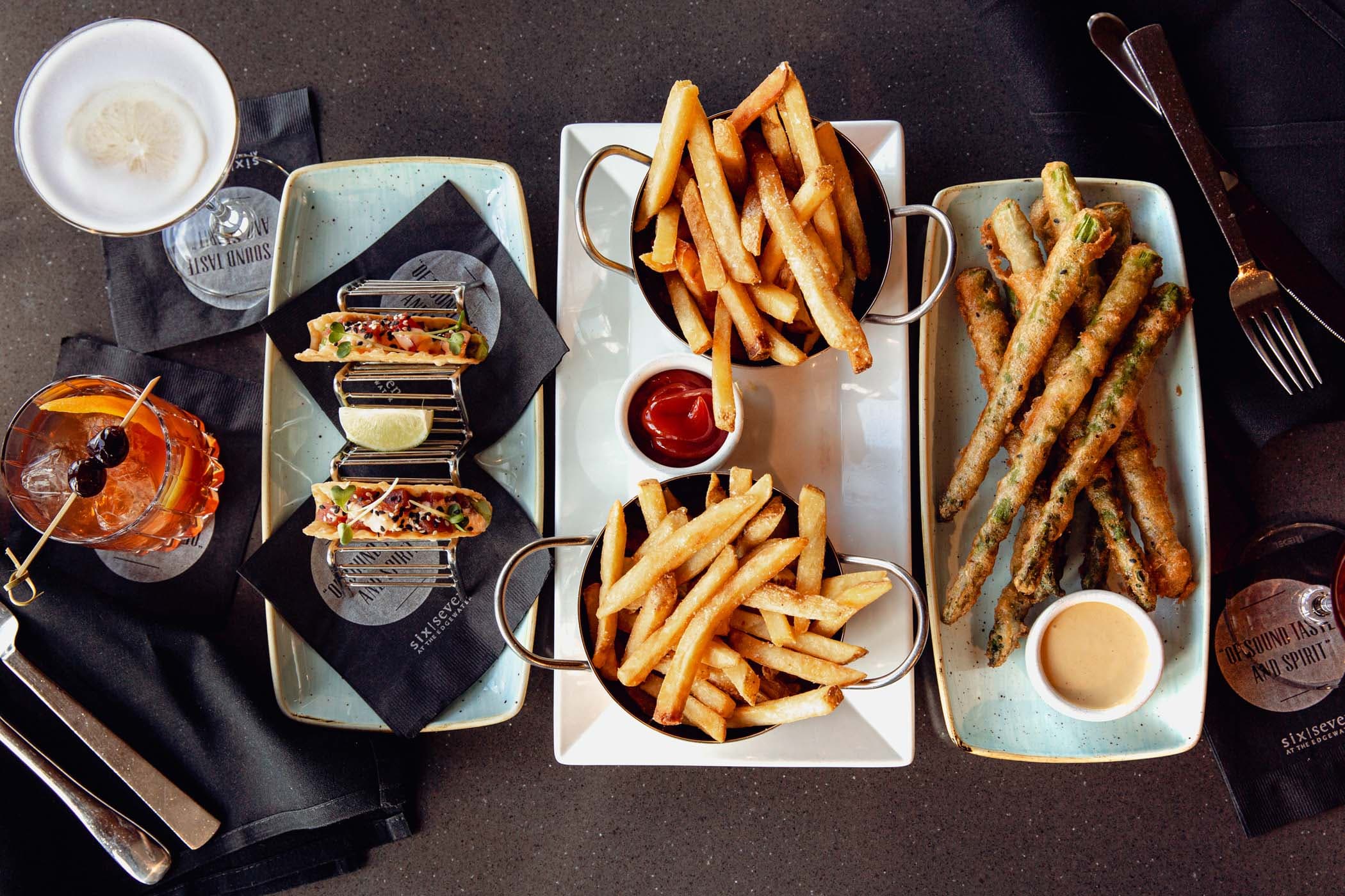 Fried asparagus, french fries, tacos, and 2 cocktails at Six Seven
