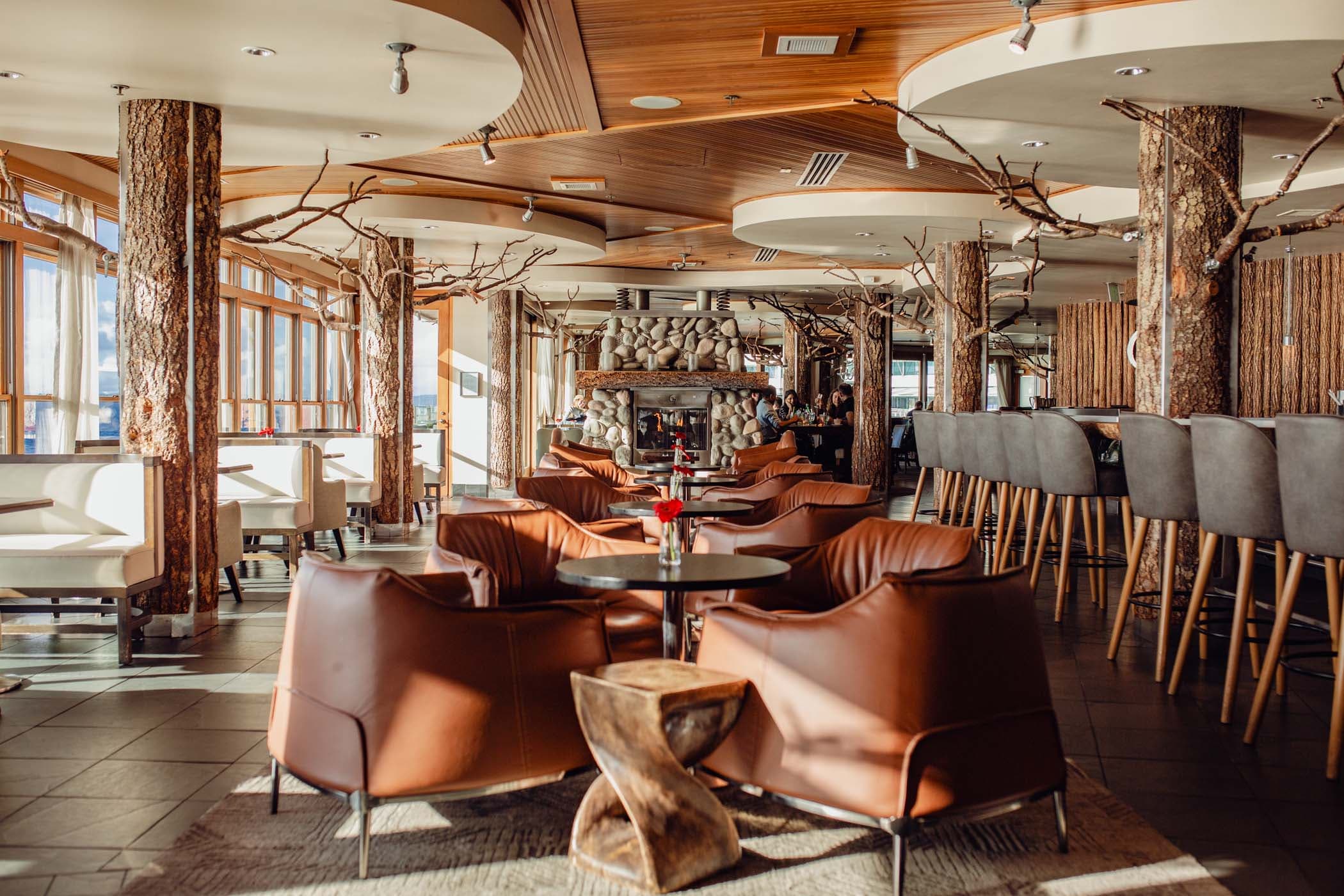 An empty Bar with beautiful decor and a stone fireplace at Edgewater