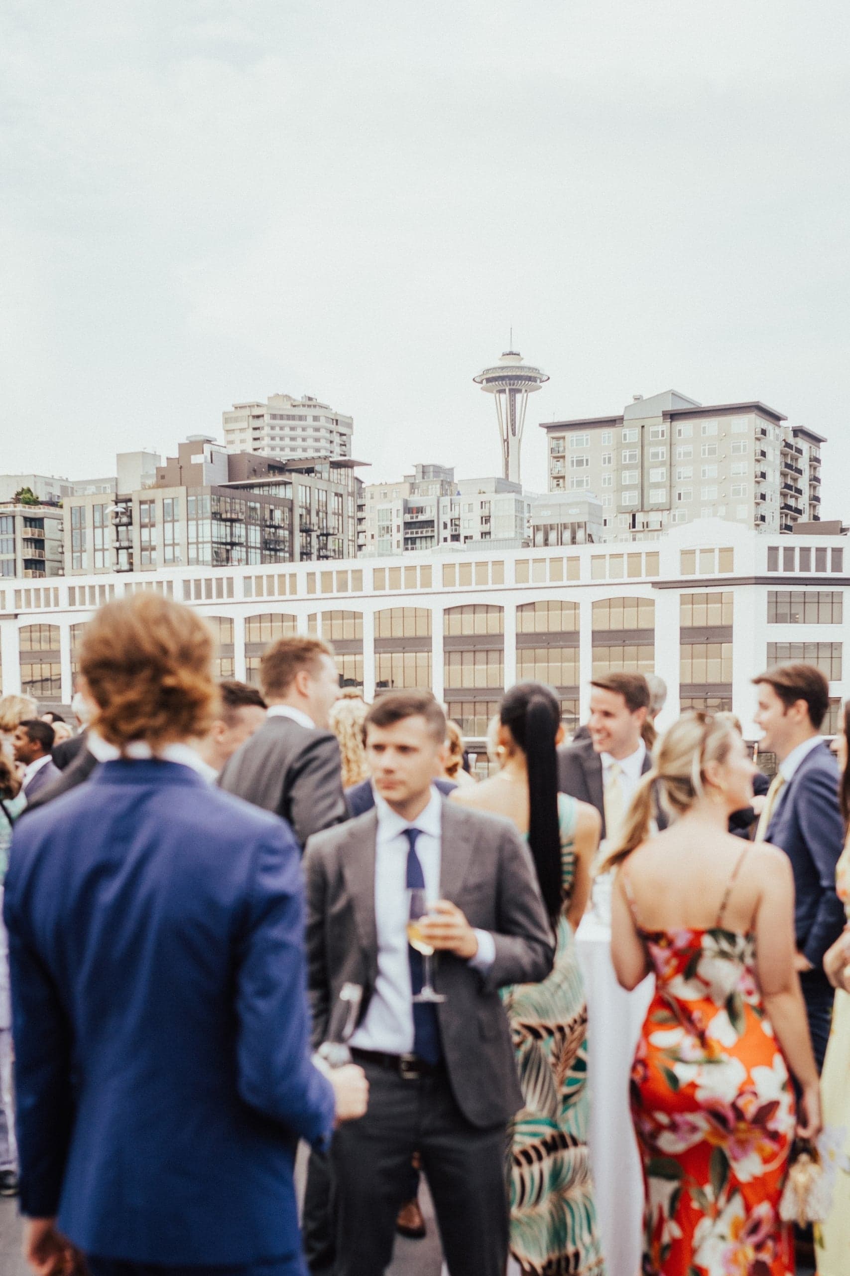 Wedding guests at a reception outdoors, at Edgewater's Terrace Room, with the Space Needle in view