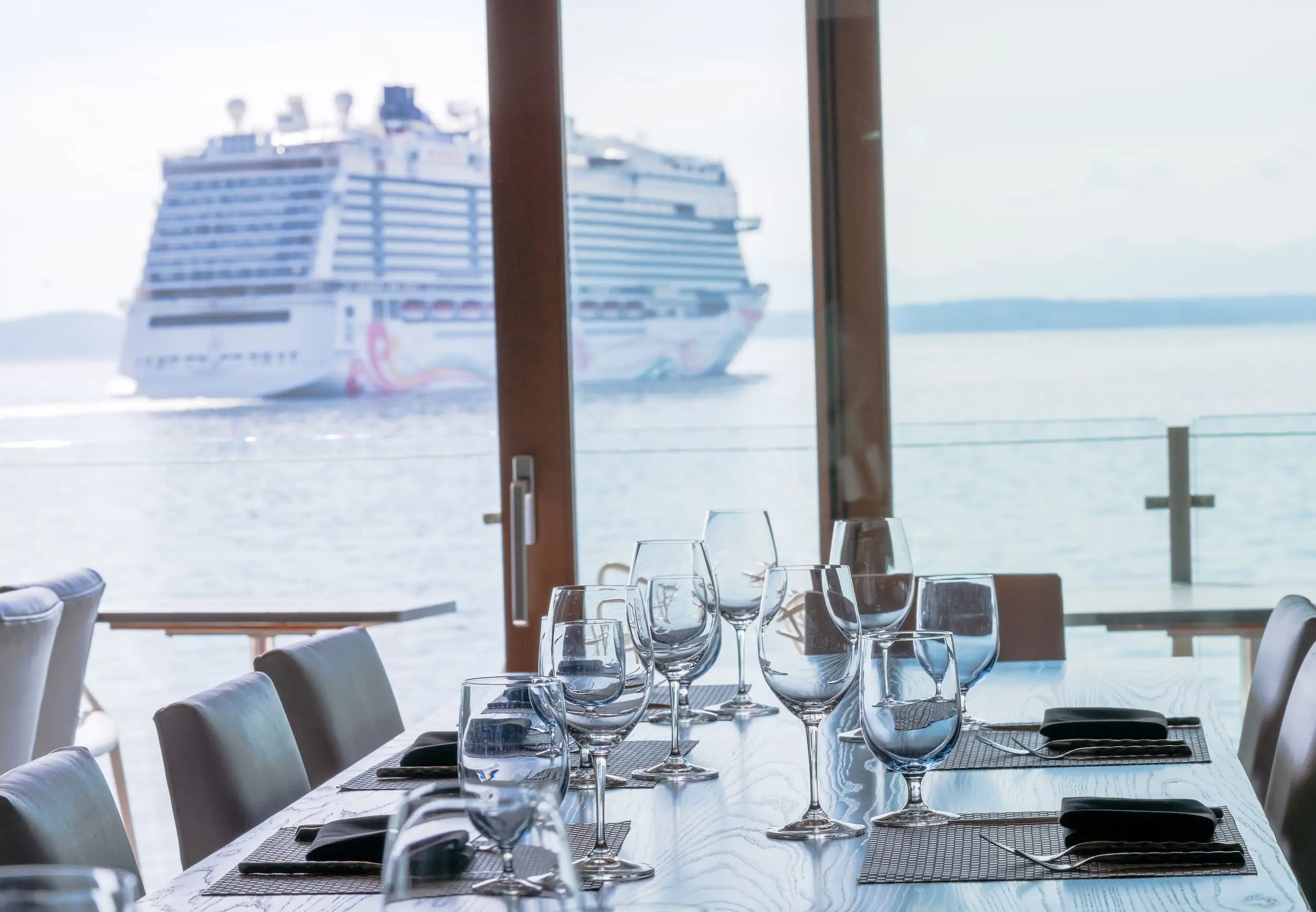 A large table seating 8 guests set up for dinner service at Six Seven Restaurant