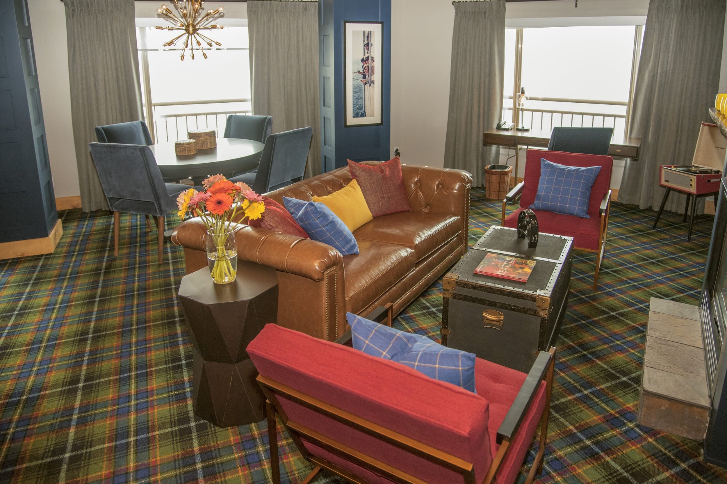The Beatles suite at Edgewater with a round table, fireplace, and lounge space