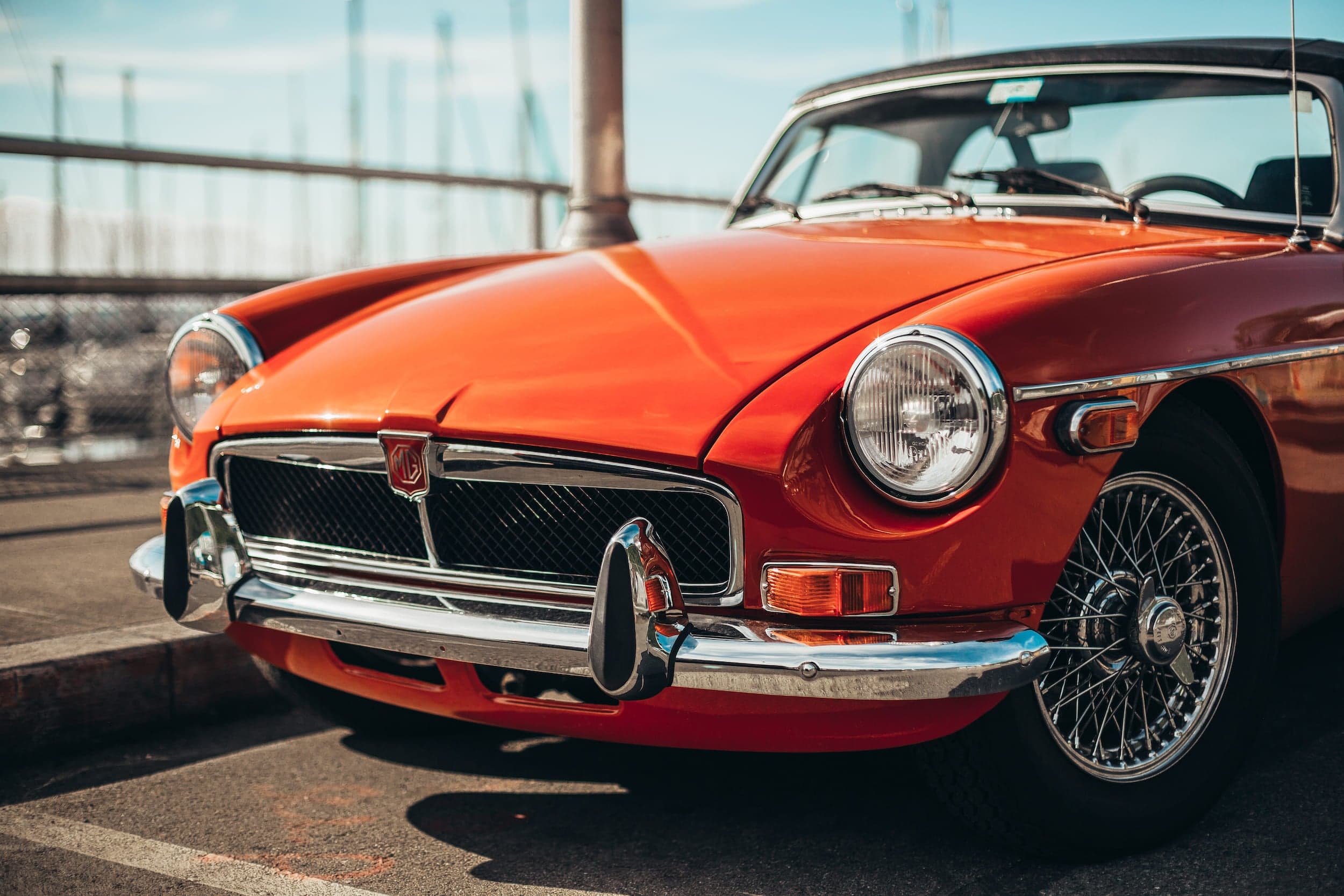 A vintage red sports car on a bridge