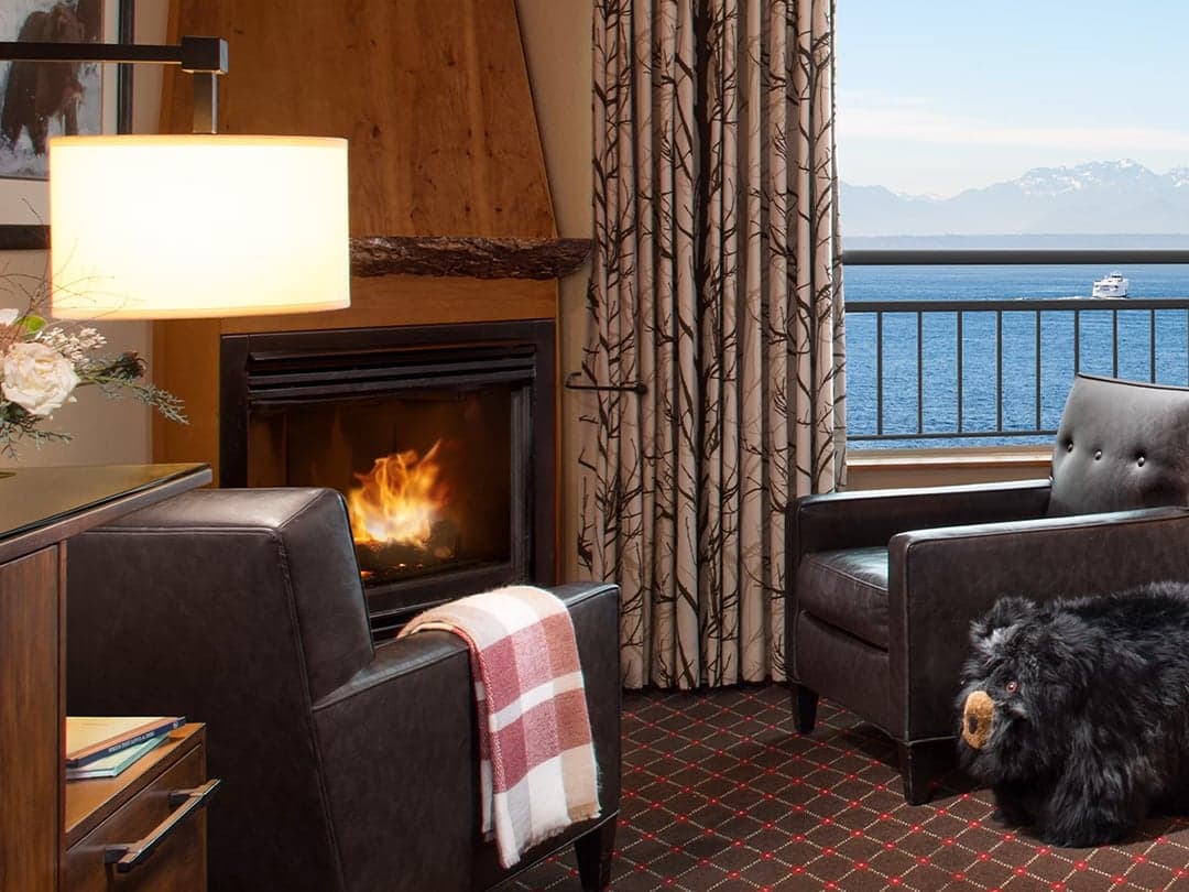 A cozy fireplace in the corner of a room at Edgewater