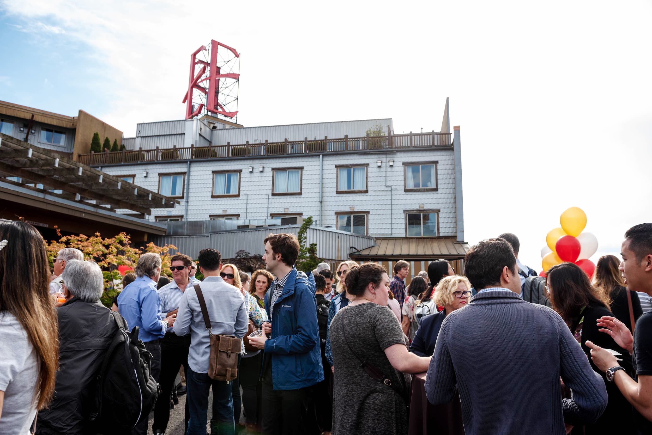 A large group of people gathering out front of Edgewater