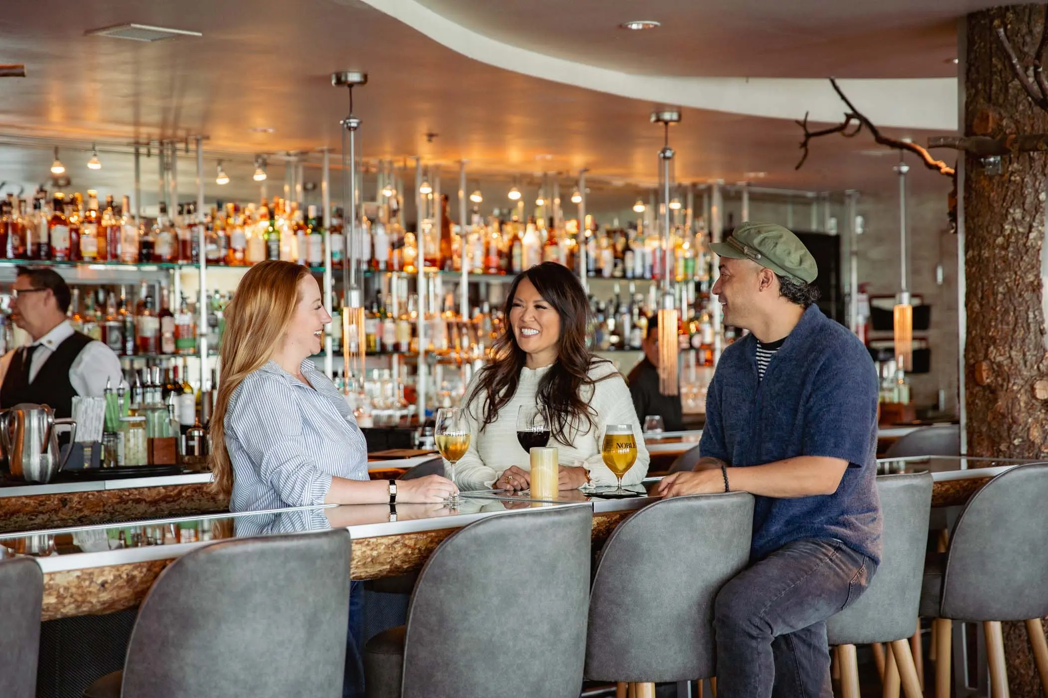 A small group of guests having drinks at the Bar at Edgewater