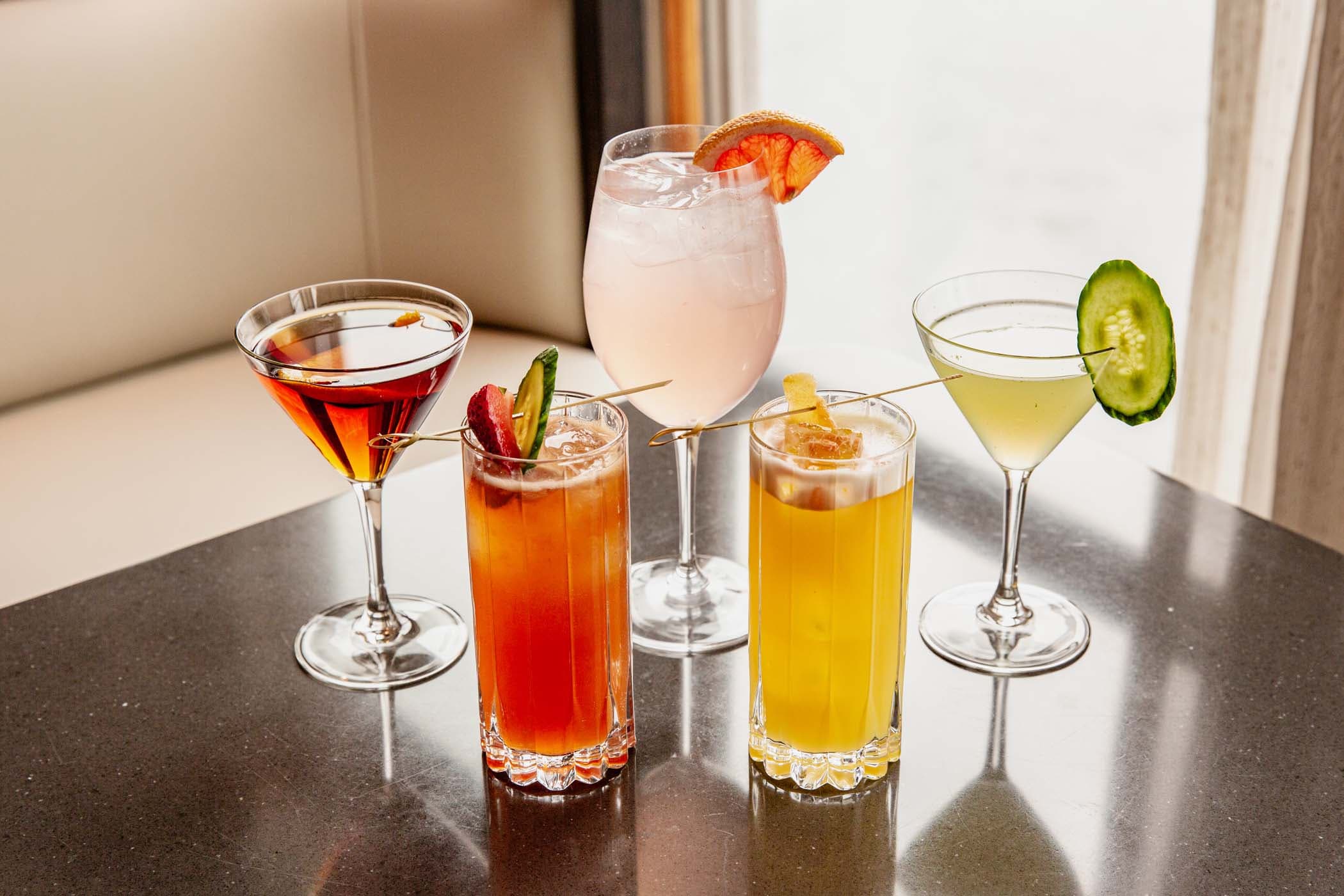 5 different types of cocktails on a table at Six Seven