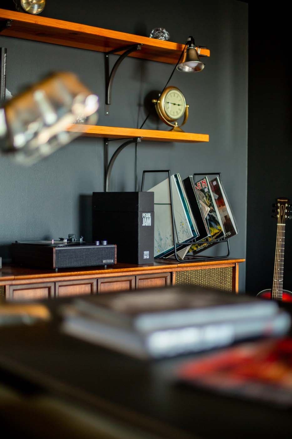 A shelf with a record player and records in the Pearl Jam Suite at Edgewater