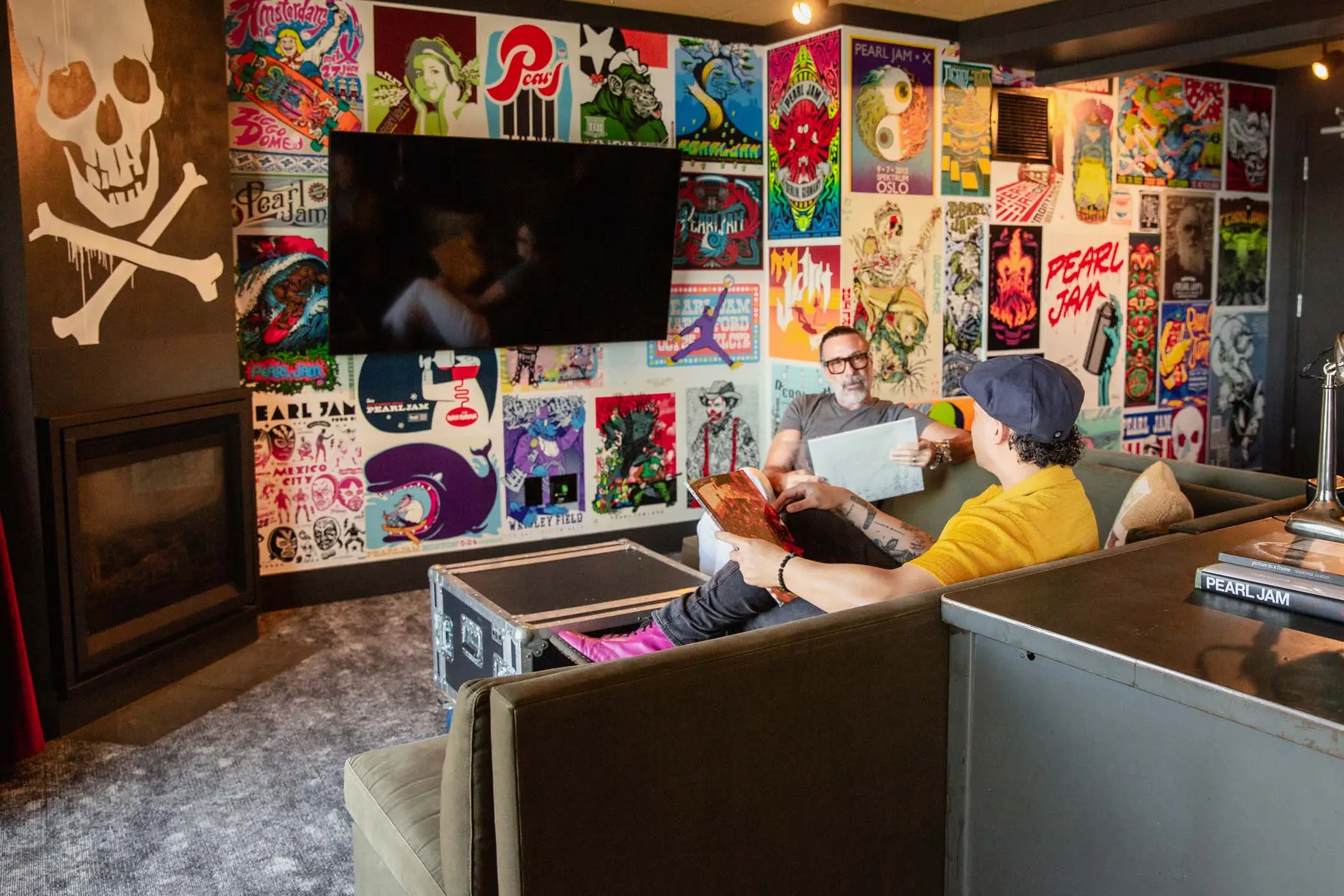 Two guests listening to music and reading in the couch in the Pearl Jam suite at Edgewater