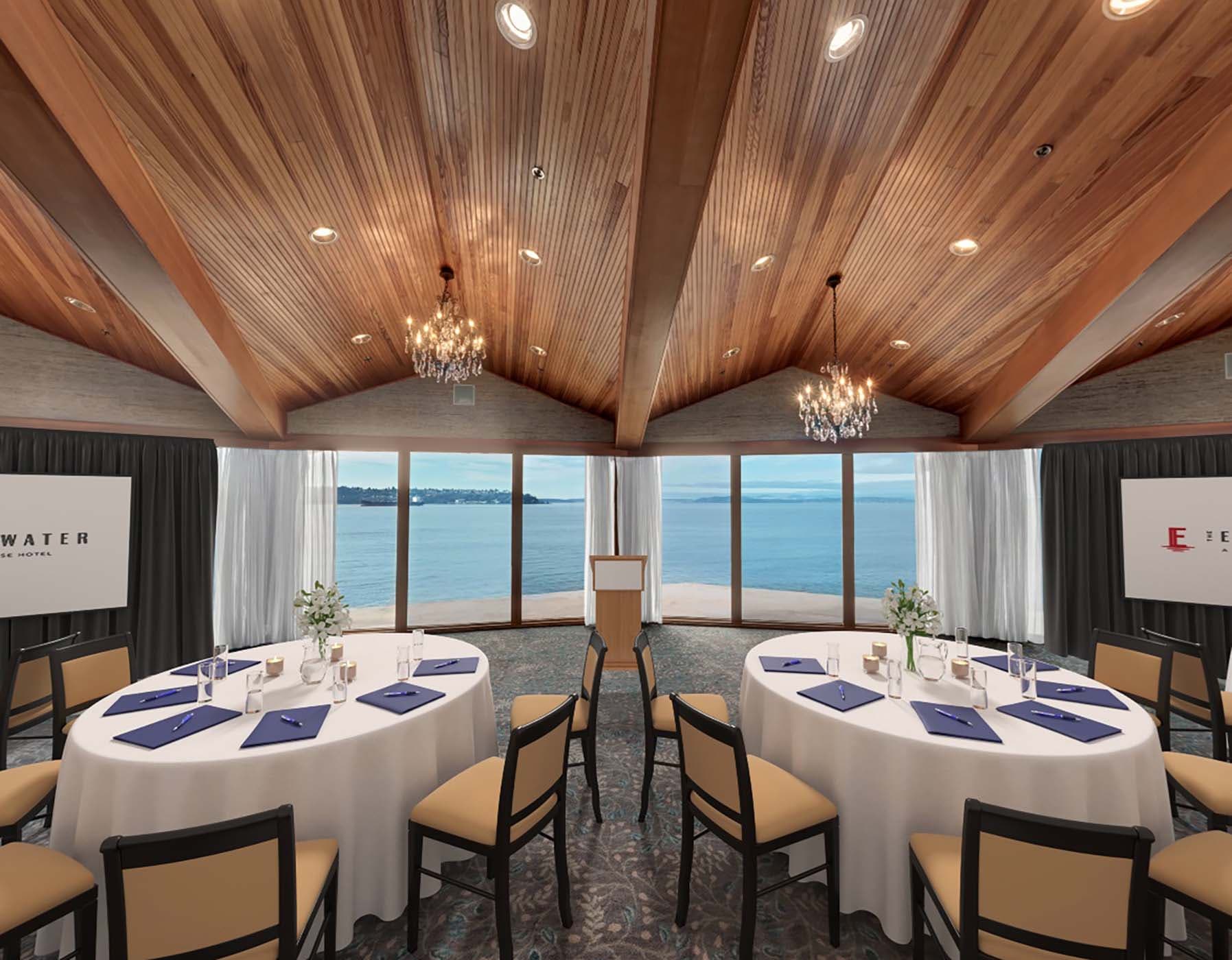 The Olympic Ballroom set for a function with round tables and a beautiful view of the water