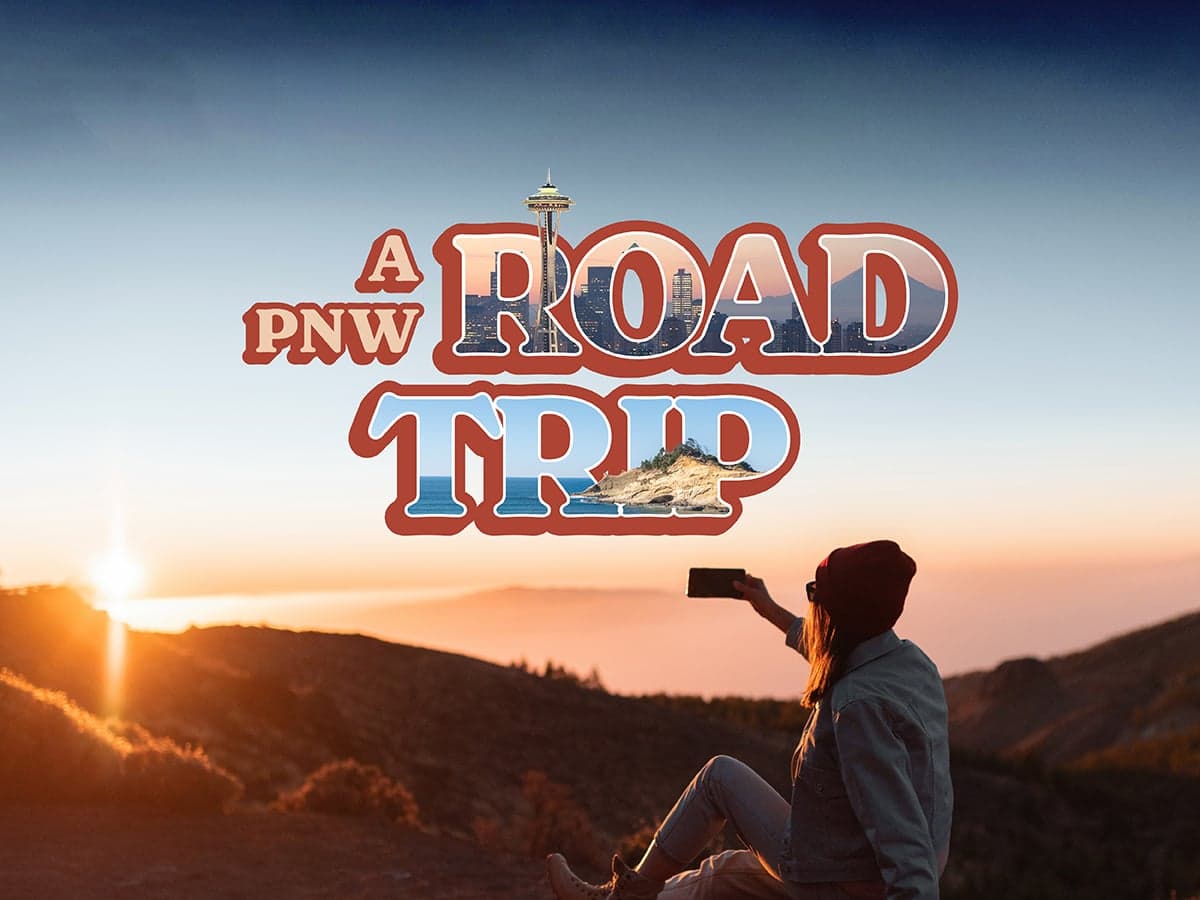 A woman taking a picture of the sunset on a road trip