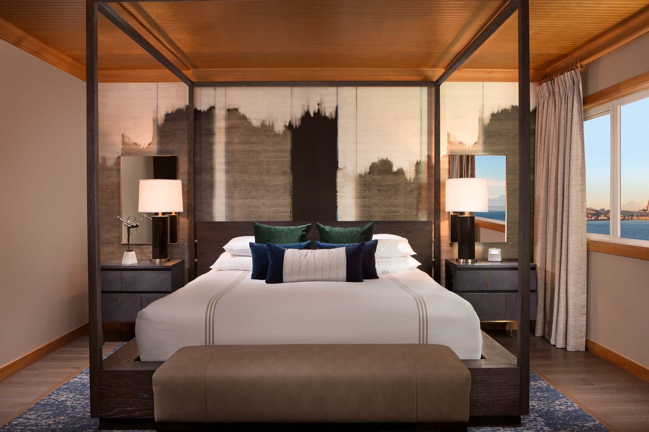 A large bed in the Penthouse Suite at Edgewater with stunning views of the water