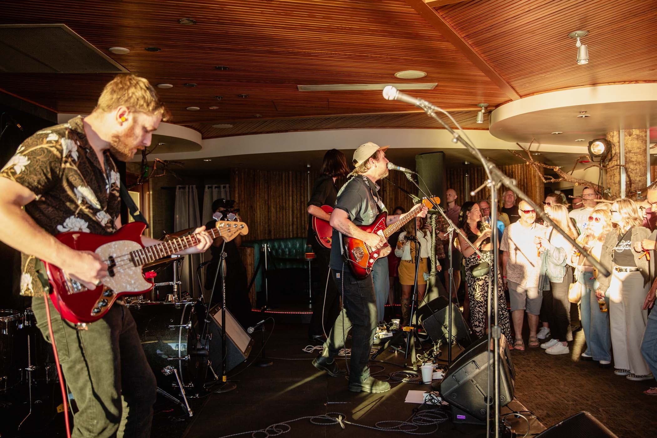 A band playing on stage at a festival in Seattle